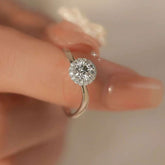 Halo lab grown diamond engagement ring on hand, close-up"