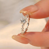 elegant white gold ring with brilliant cut center stone and side accents