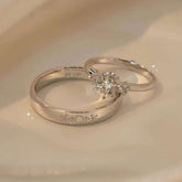 Elegant 18K white gold diamond engagement and wedding ring set for couples, featuring round brilliant center stone and engraved men’s band.