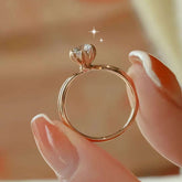 Close-up of blooming-lotus claw setting lifting round brilliant diamond