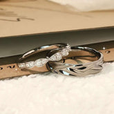 close up of sterling silver couple rings set with twisted leaf pavé band and polished men’s ring