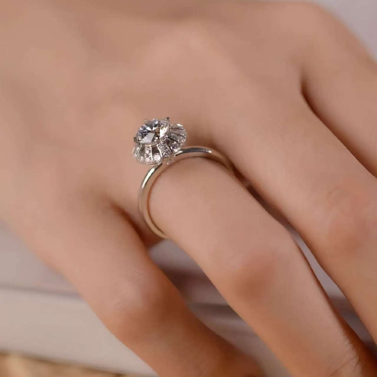 Angled close-up showing tapered baguette fan around round center stone