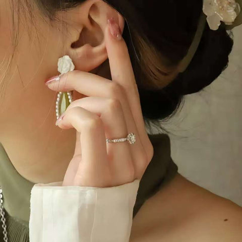 Oriental bamboo engagement ring styled with green pleated dress