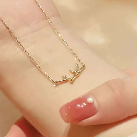 Bamboo necklace resting on wrist, showcasing delicate cable chain