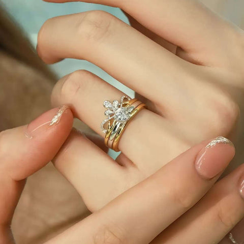Close-up of floral tiara enhancer and solitaire bands in yellow gold
