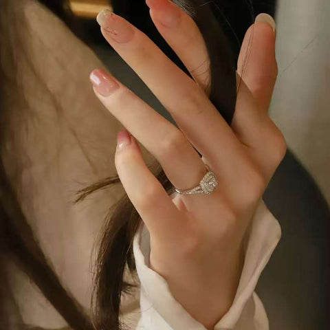 halo cushion cut diamond ring on hand