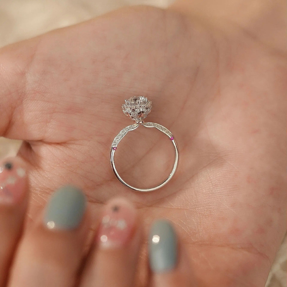underside of halo ring showing hidden ruby accents beneath crown, 14K gold setting