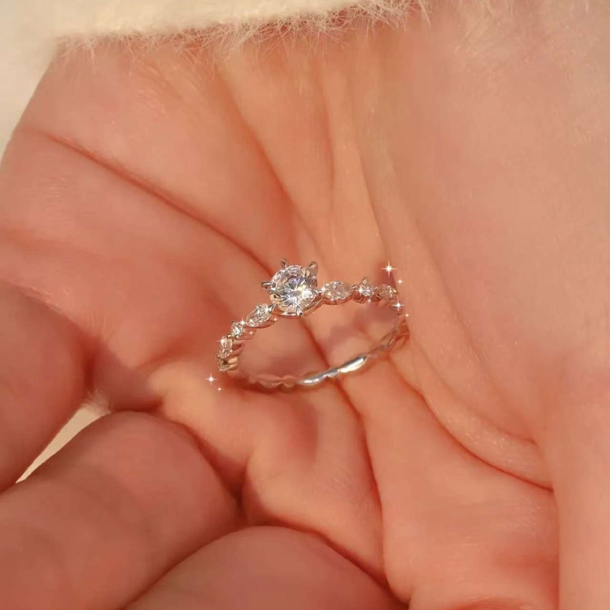 close up of floral design diamond engagement ring in 18k white gold