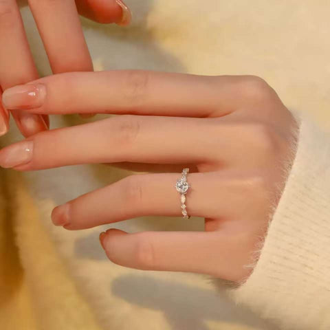 delicate lab grown diamond ring with marquise and round side stones on hand