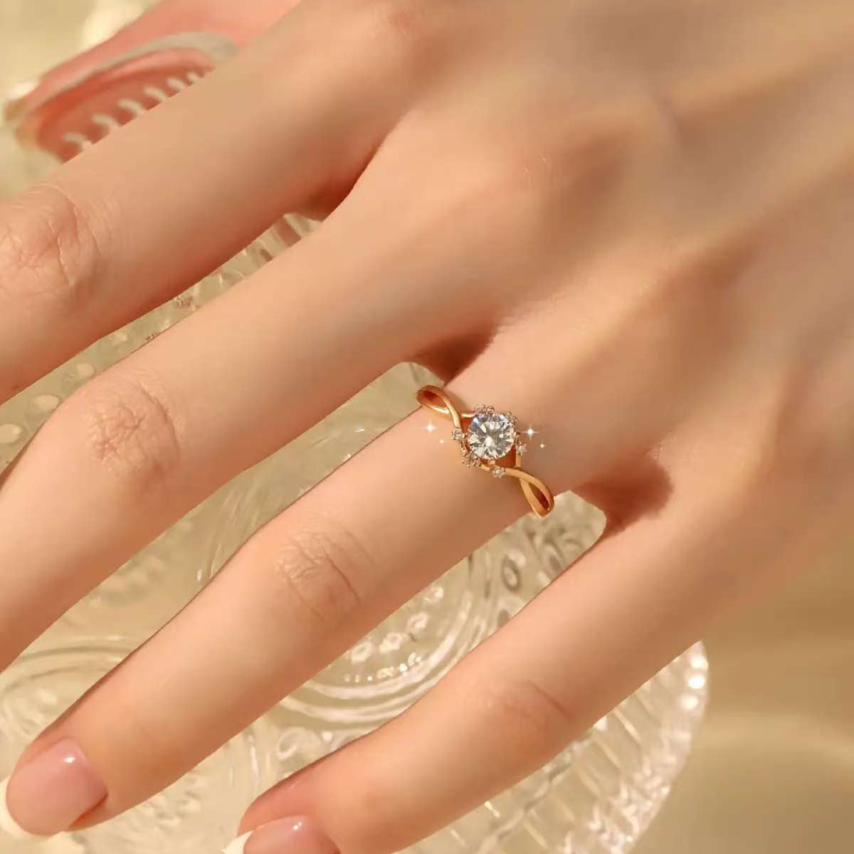 Infinity twist solitaire ring on hand, 0.6 ct round lab diamond