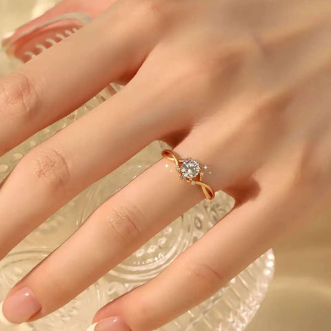 Infinity twist solitaire ring on hand, 0.6 ct round lab diamond