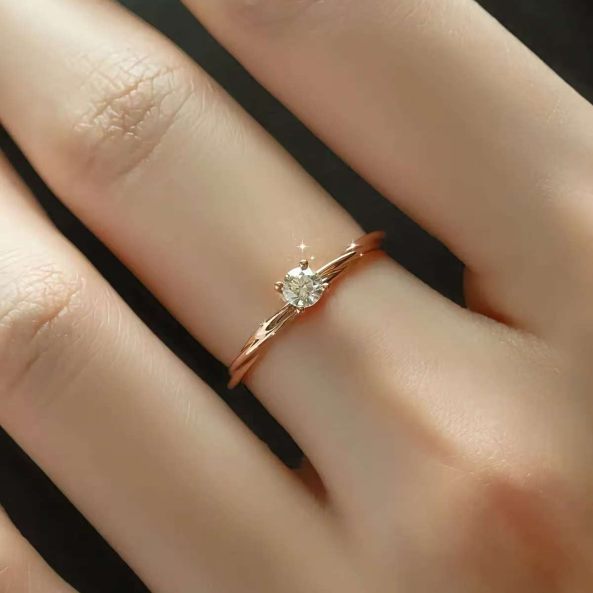 dainty twisted gold solitaire ring worn on finger
