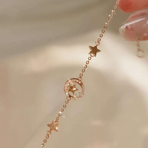Star station details and pavé crescent moon charm on 18k gold bracelet
