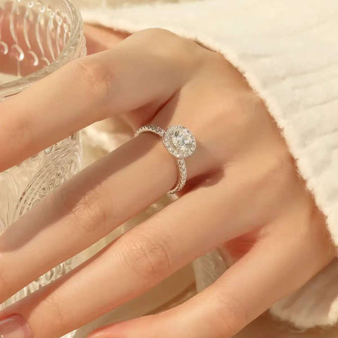 
Side view of round halo ring catching natural light on hand