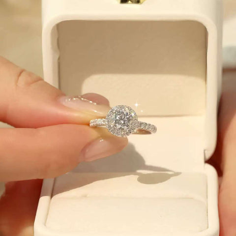 Sunlit Halo ring displayed in cream jewelry box with hidden halo visible
