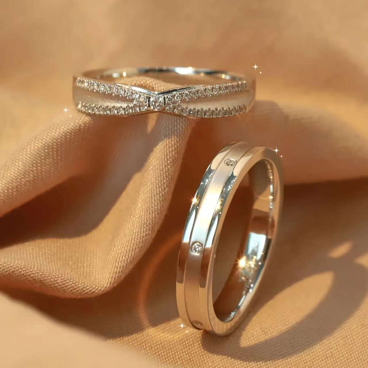 Feminine pavé bow ring and minimalist men's band worn on hand