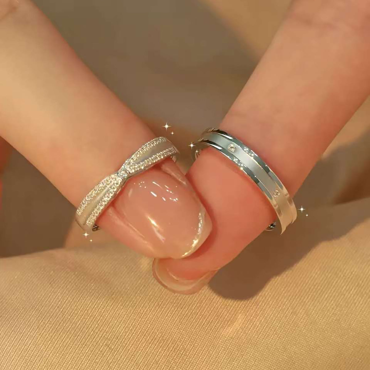 couple ring set displayed in jewelry box, bow and diamond details