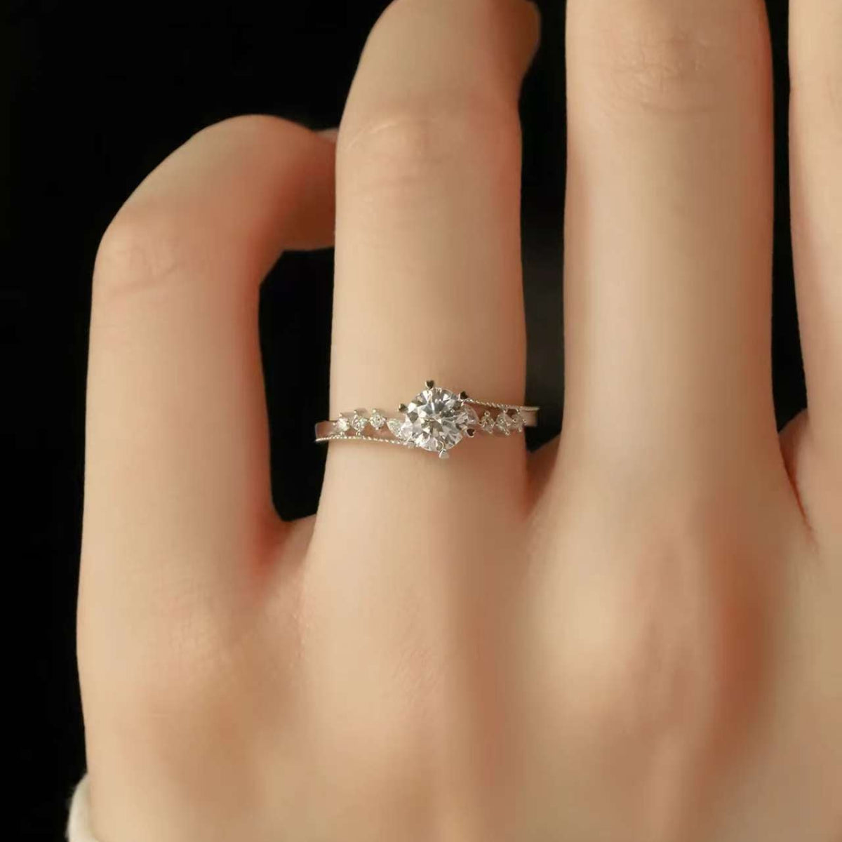 Natural diamond halo engagement ring on woman's hand, elegant wedding jewelry