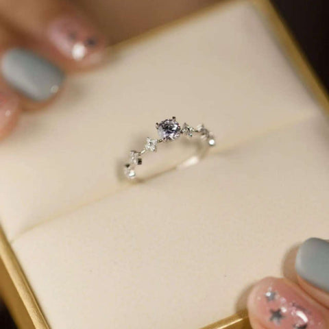 round lab diamond vine ring resting in cream ring box, minimalist style