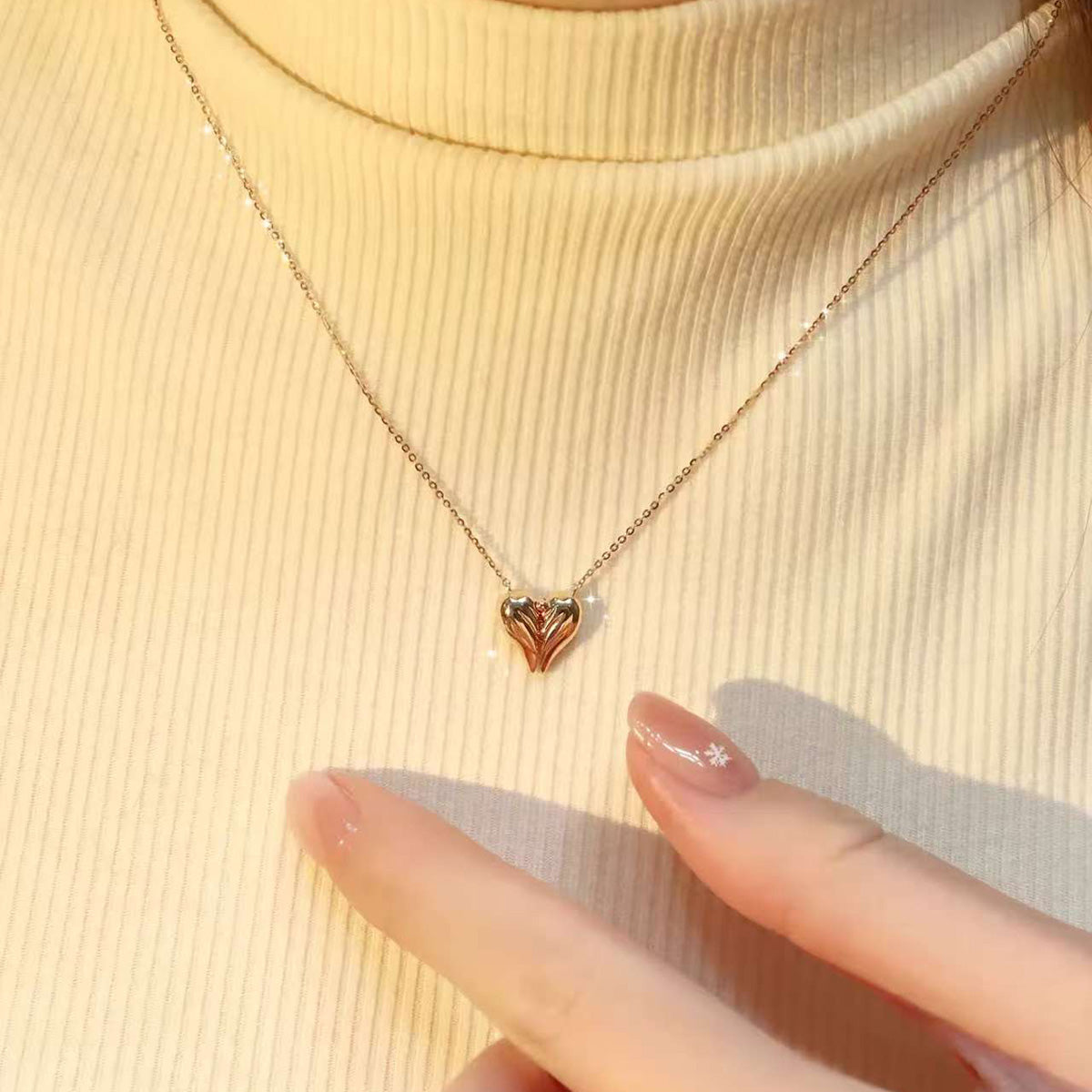 Angel Heart lab-grown diamond necklace styled on a cream turtleneck