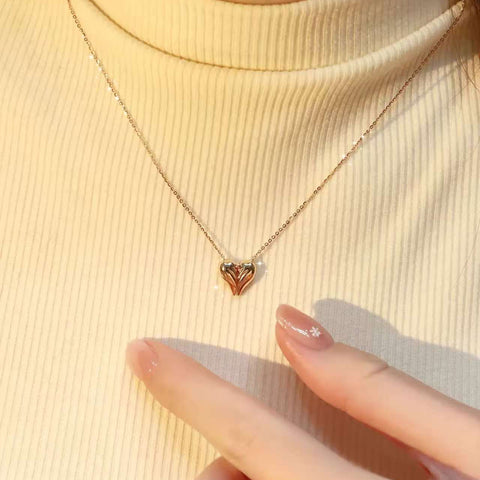 Angel Heart lab-grown diamond necklace styled on a cream turtleneck