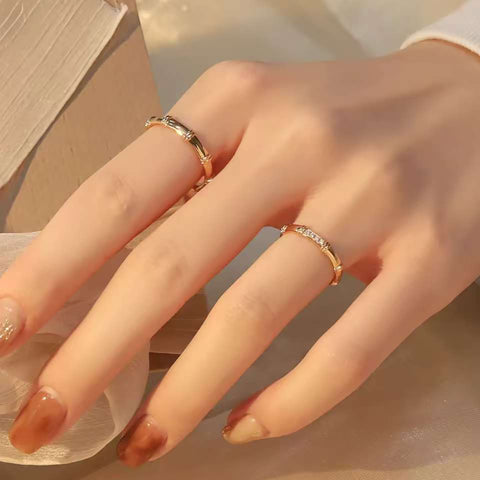 Hand pose displaying plain bamboo ring on index and pavé bamboo ring on ring finger