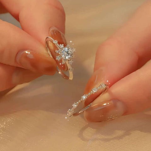 Two fingers holding solitaire and matching band, showing diamond sparkle close-up