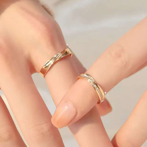 Close-up of finger spread showing plain crossover band and diamond crossover band