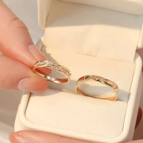 Diamond and plain twist rings displayed side-by-side in ivory jewelry box