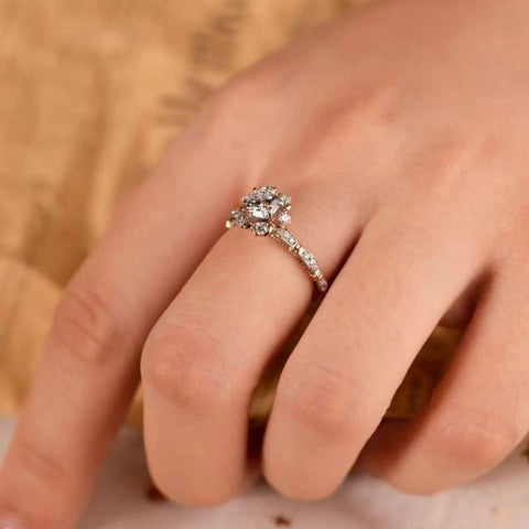 on-hand view of 1ct floral cluster ring, slim band elongates fingers