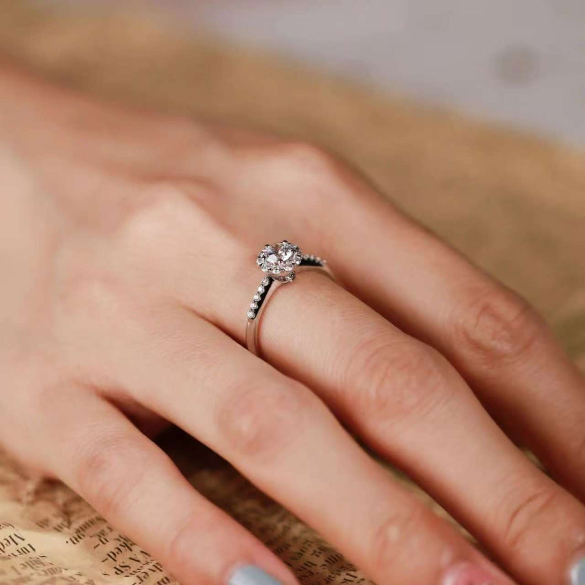 lab-grown diamond floral halo ring captured in natural light, dainty bridal jewelry