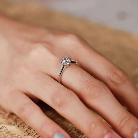 lab-grown diamond floral halo ring captured in natural light, dainty bridal jewelry