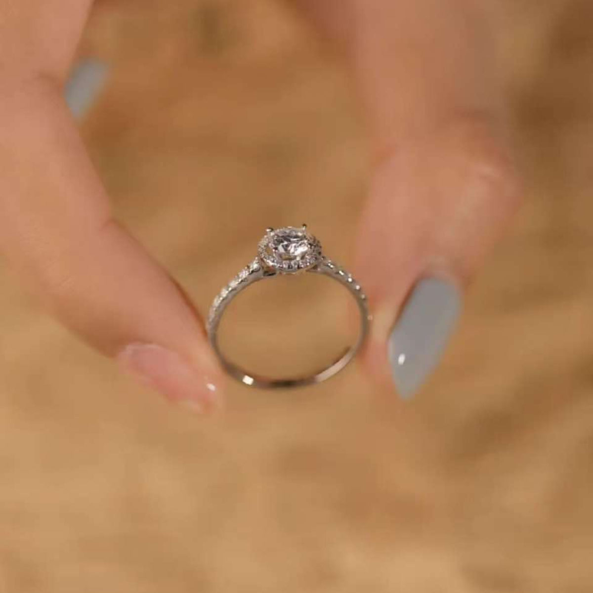 Minimalist luxury halo ring displayed, round cut center