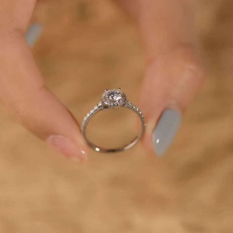 Minimalist luxury halo ring displayed, round cut center