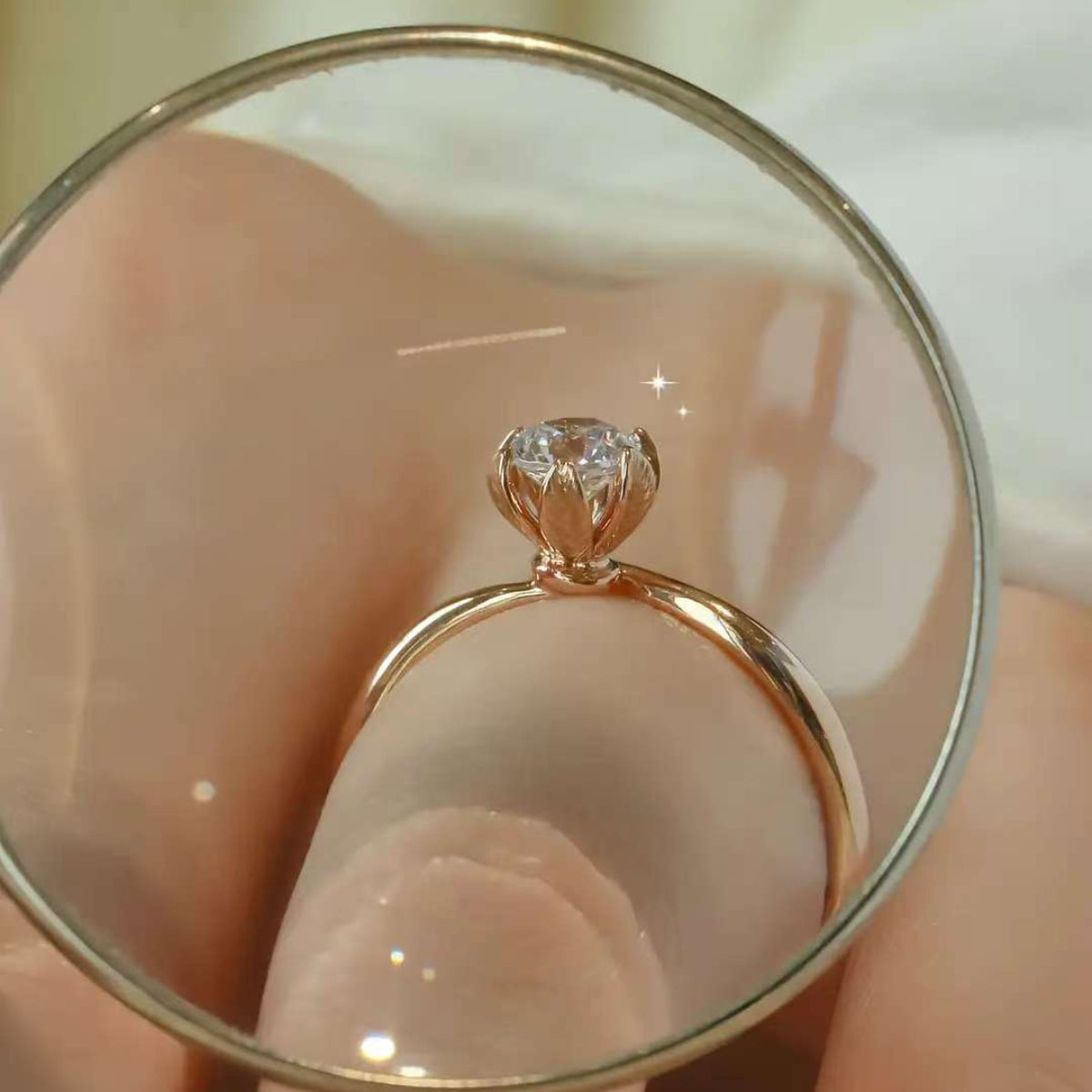 Magnified view of lotus-petal crown holding a 0.30 ct diamond on rose gold ring