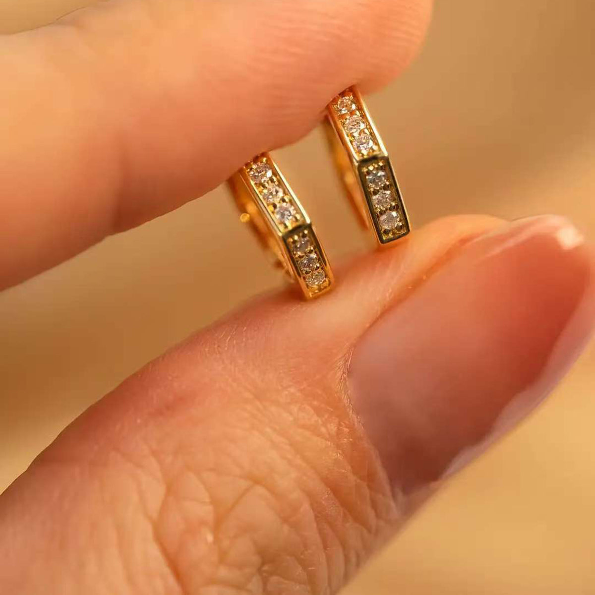 Fingers holding pair angled to show inner gallery