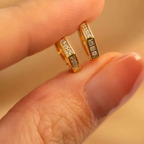 Fingers holding pair angled to show inner gallery