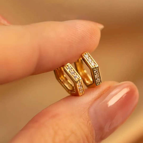Fingers holding pair angled to show inner gallery