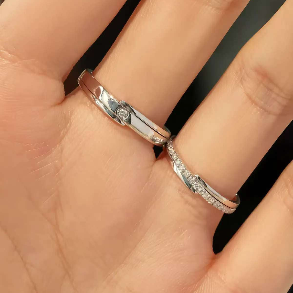 Minimalist matching lab diamond wedding bands worn on couple’s ring fingers
