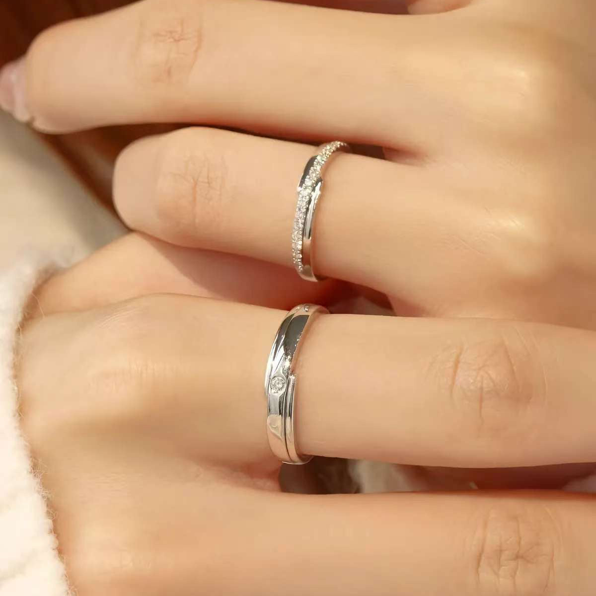 Close-up pavé women’s lab diamond band and men’s solitaire wedding band