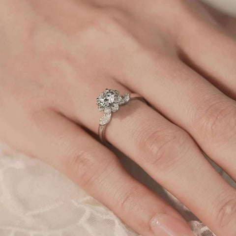 floral halo lab diamond ring on hand, marquise accents, slim 18K gold band