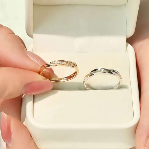 Close-up of rose gold and white gold diamond rings in jewelry box, contemporary twist design