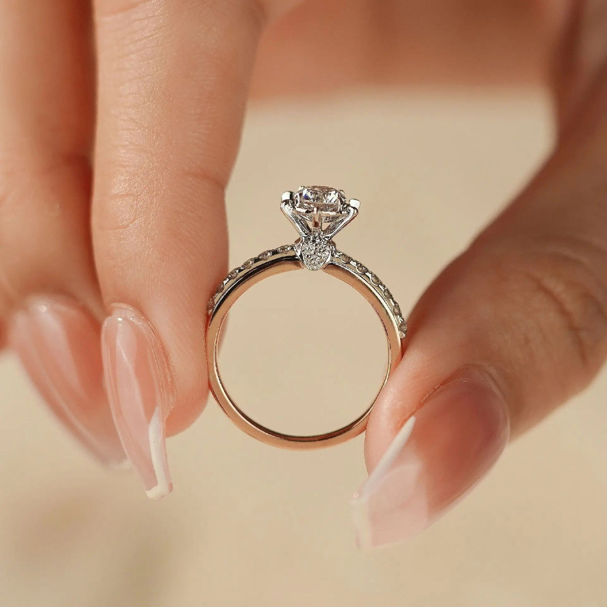 side view lab diamond ring on finger, hidden pear diamond under gallery