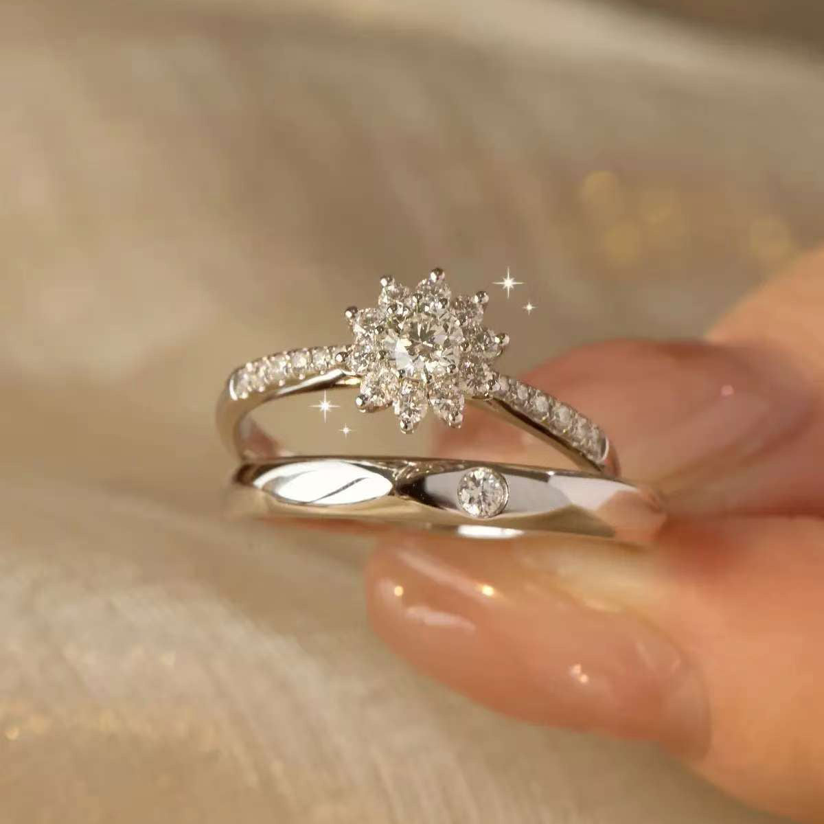 
Hand model wearing matching snowflake cluster diamond couple rings with soft golden background