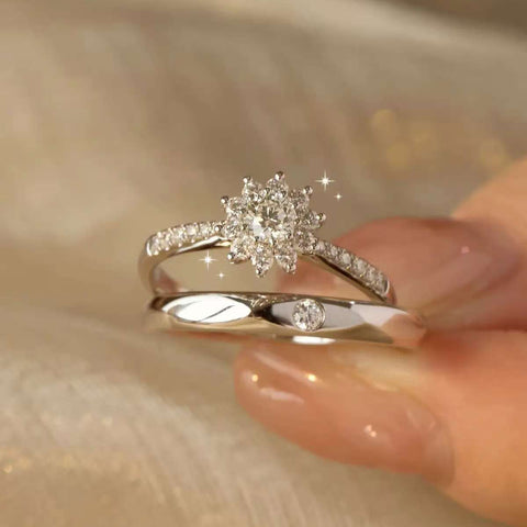 
Hand model wearing matching snowflake cluster diamond couple rings with soft golden background