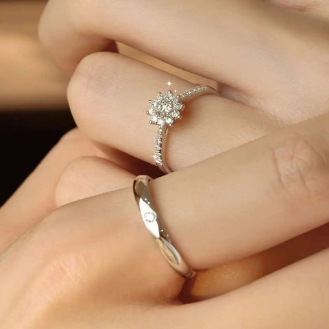 Close-up of snowflake cluster lab grown diamond ring set in 14K gold, on a woman's hand
