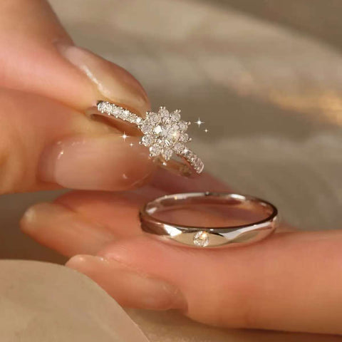 Detailed shot of pavé snowflake cluster diamond ring and men’s round lab diamond wedding band