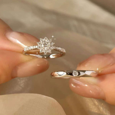Elegant bridal snowflake cluster diamond engagement ring and men’s minimalist diamond wedding band

