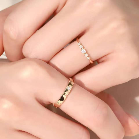 Hands wearing diamond slim ring and matte panel band stacked on adjacent fingers
