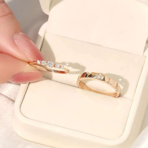 Half-eternity and brushed bezel diamond rings displayed in ivory jewelry box